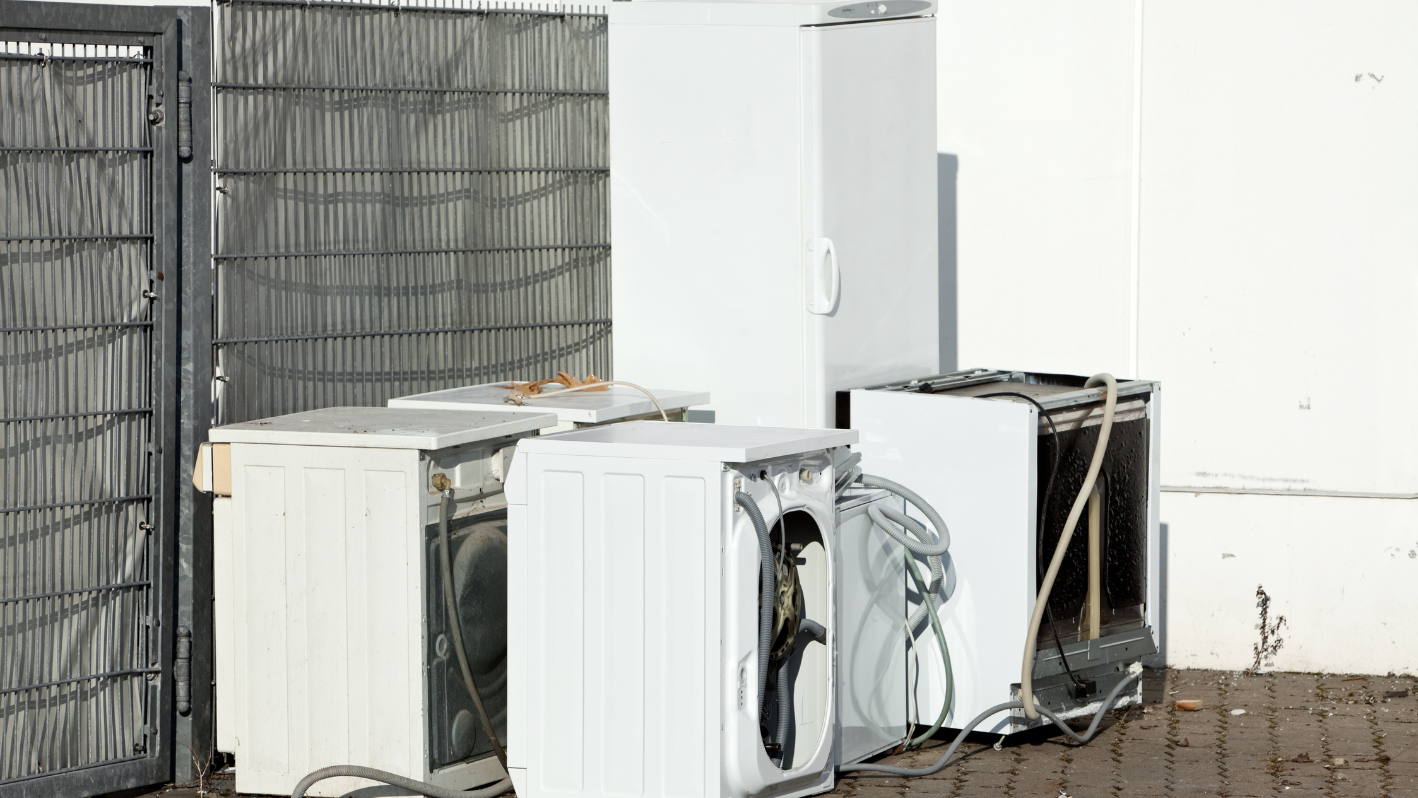 A couple of refrigerators sitting next to each other